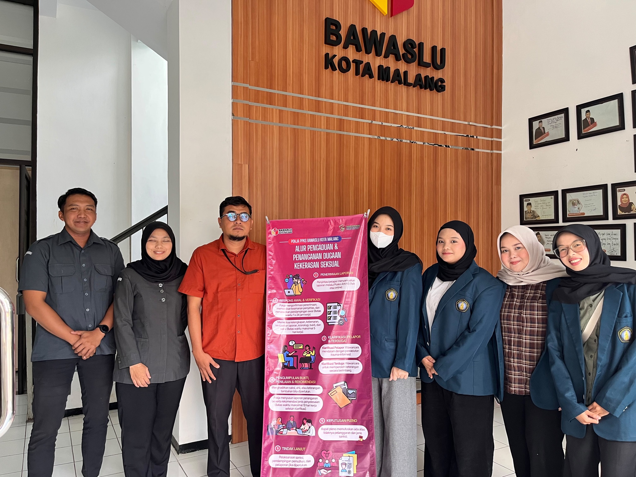 Mahasiswa MBKM Universitas Brawijaya serahkan banner Alur Pengaduan dan Penanganan Dugaan Kekerasan Seksual kepada M. Hasbi Ash Shiddiqy selaku Anggota Bawaslu Kota Malang (kemeja jingga).